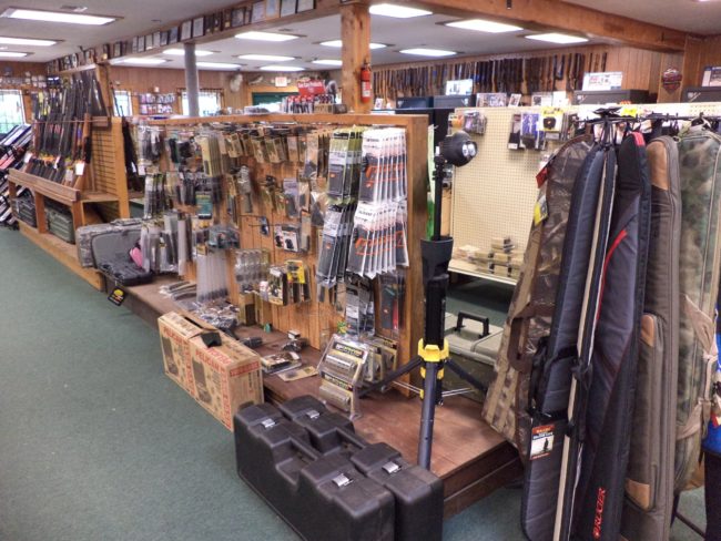 Wide selection of firearm accessories, rifle cases, scopes, and gun parts inside Pickett Weaponry's retail showroom in Newberry, FL.