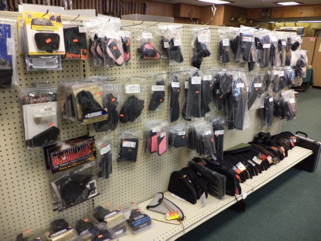 Wall display of holsters at Pickett Weaponry in Newberry, FL.
