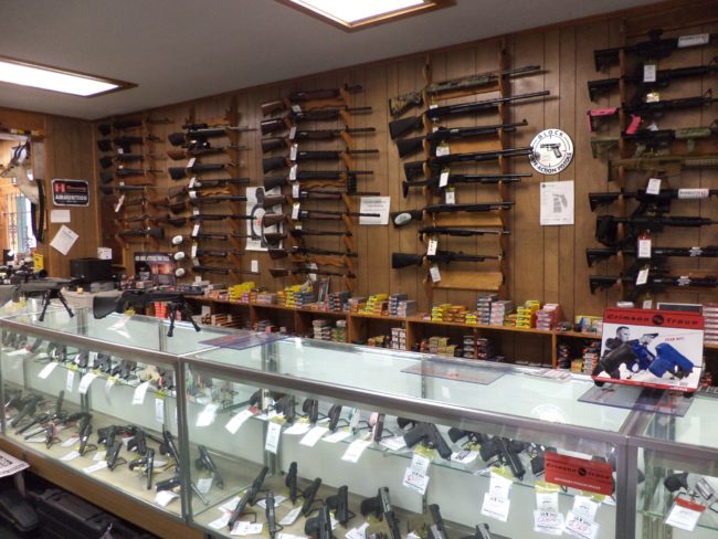 Wide selection of firearm accessories, rifle cases, and handguns inside Pickett Weaponry's retail showroom in Newberry, FL.