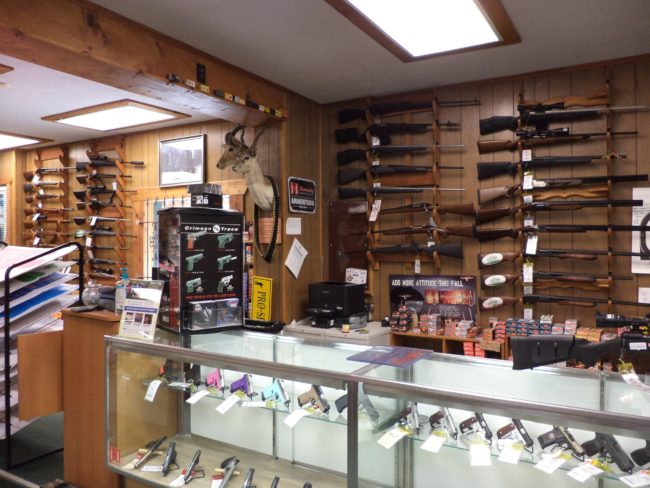 Wide selection of firearm accessories, scopes, and gun parts inside Pickett Weaponry's retail showroom in Newberry, FL.